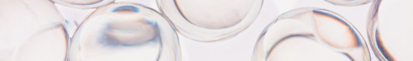 Close-up of glass vials with liquid on a light background