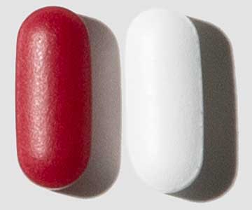Two oval-shaped pills, one red and one white, placed side by side on a plain background.