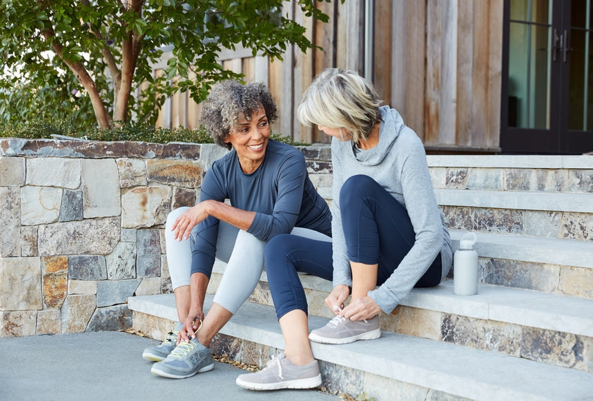 women sitting on stairs smiling