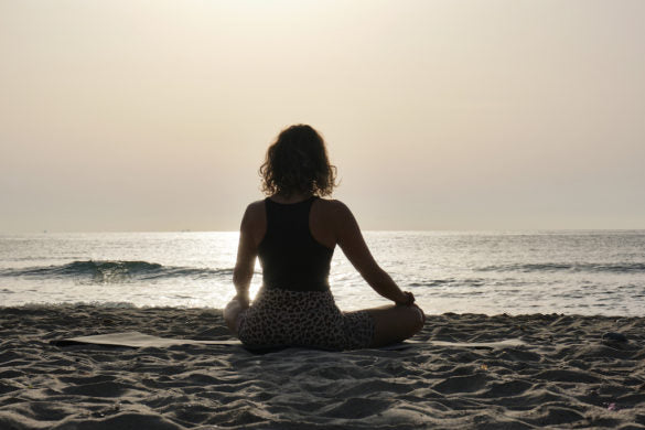 Woman Doing Yoga on Beach