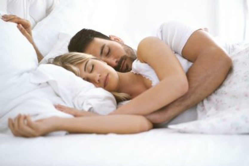 man and woman sleeping in bed