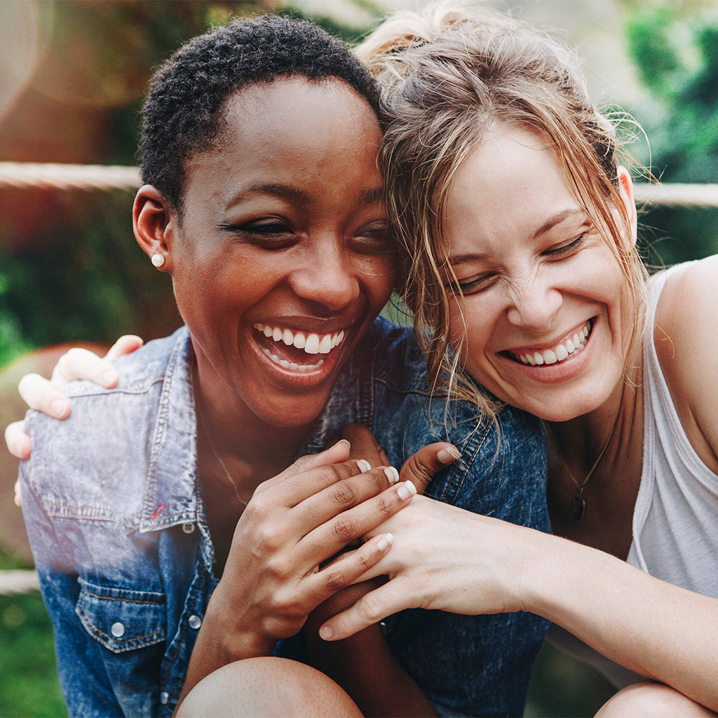 women hugging and smiling