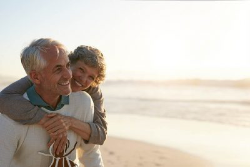 woman and man laughing and smiling on beach