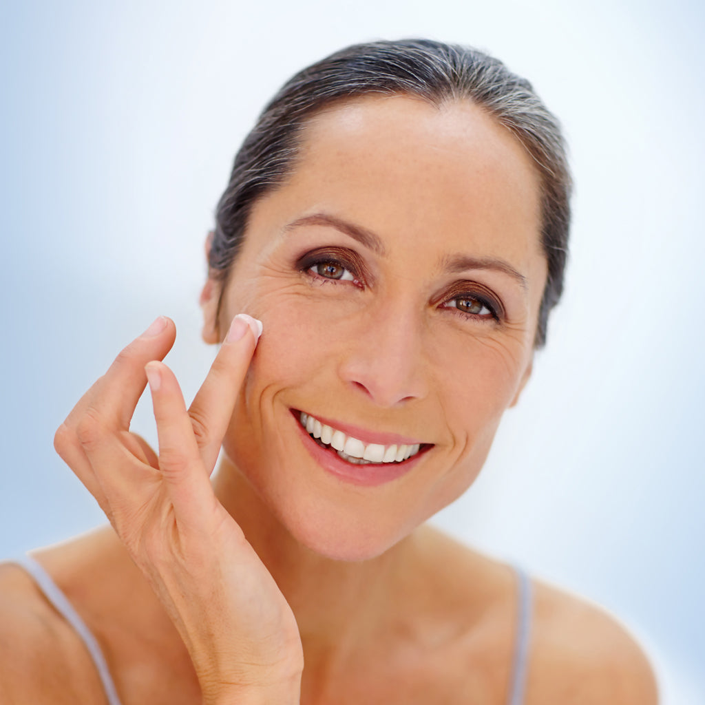 woman moisturizing face