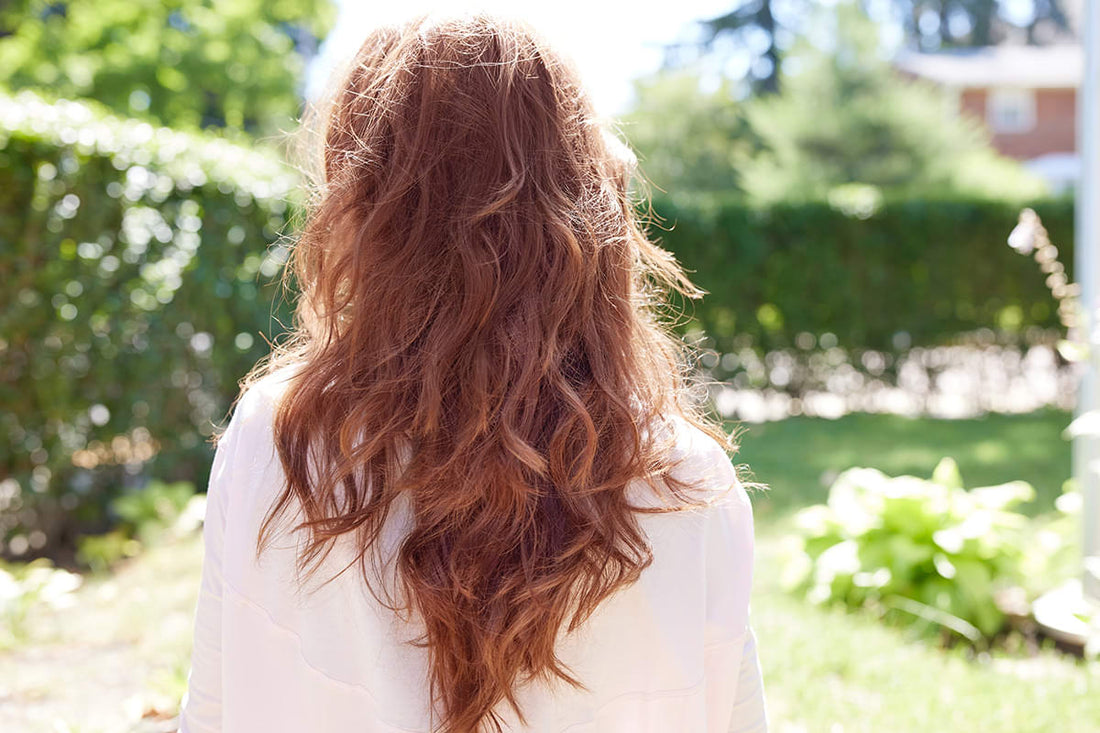 Woman with long, thick, gorgeous grey hair falling down her back