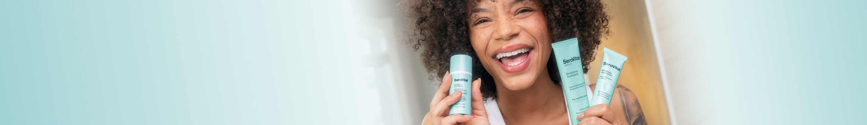 Woman holding three blue smile care products against a light background