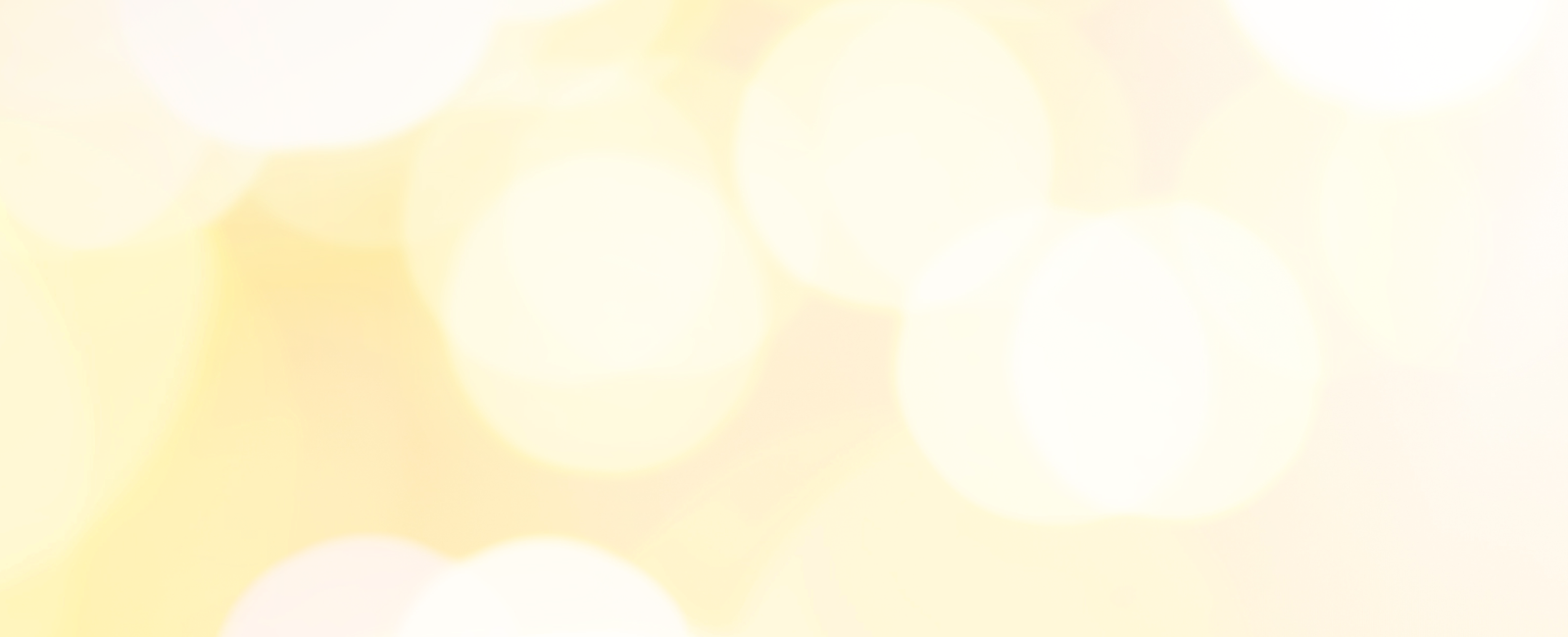 A blurry background of warm, bright yellow and white bokeh lights, suggesting a festive or celebratory atmosphere.