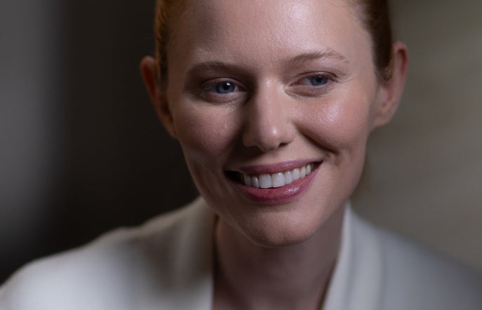Woman wearing a white robe with a blurred background