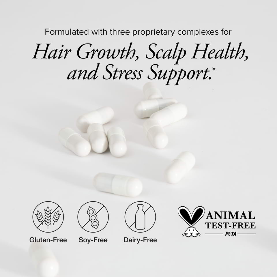 White capsules lying on a grey background with icons showing Hair Regeneres ADVANCED is gluten free, soy free, and dairy free, PETA certified.