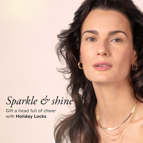 A woman with thick, brown hair and gold jewelry looking into the camera with the text Sparkle and shine, gift a head full of cheer with holiday locks