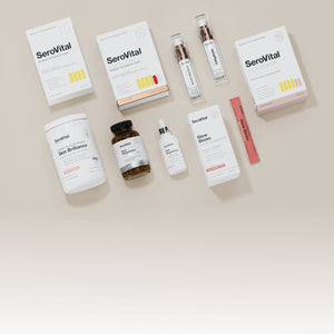 A flat lay of various SeroVital anti-aging and skin health products, including boxes, bottles, a tub, and individual packets, on a neutral background.
