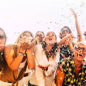 Group of people celebrating with confetti in a festive setting