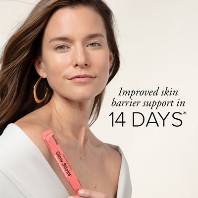 A beautiful white woman with glowing skin holding a packet of anti-aging powder Glow Sticks next to text that says improved skin barrier support in 14 days