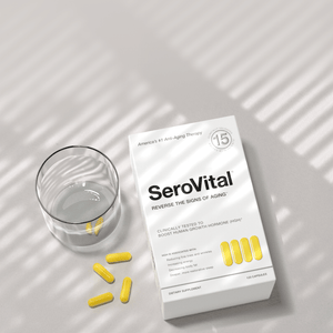 White box of SeroVital anti-aging supplement with yellow capsules and a glass of water.