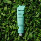SeroVital toothpaste tube on a bed of green leaves