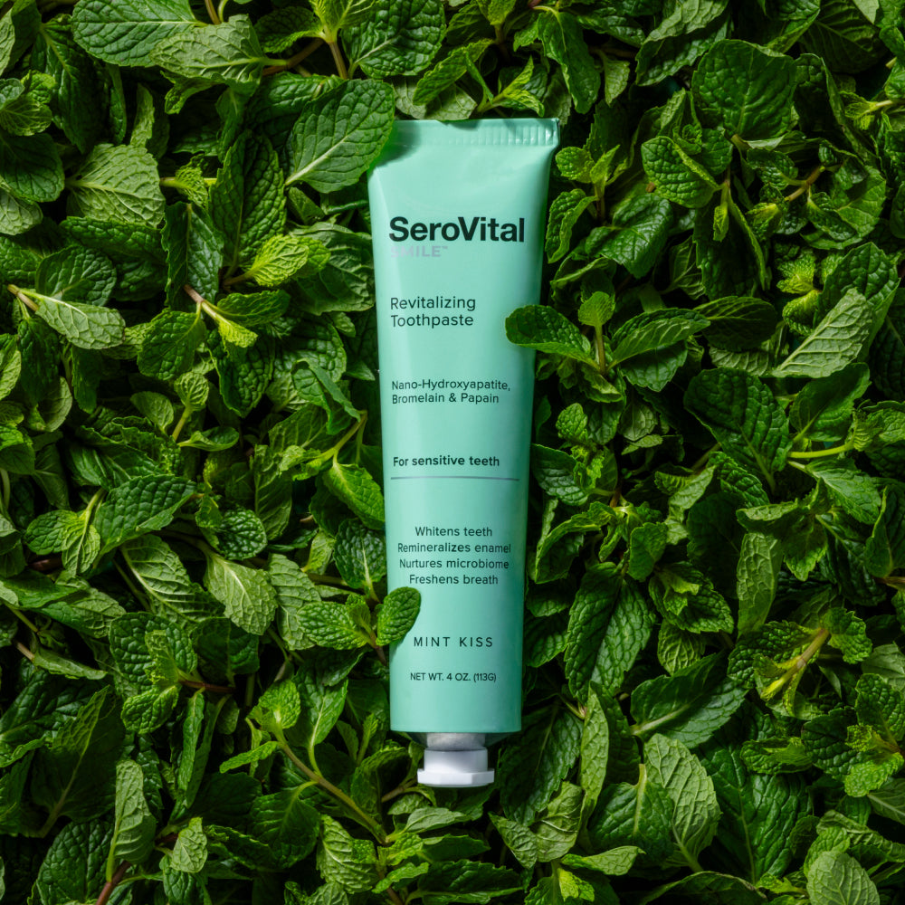 SeroVital toothpaste tube on a bed of green leaves