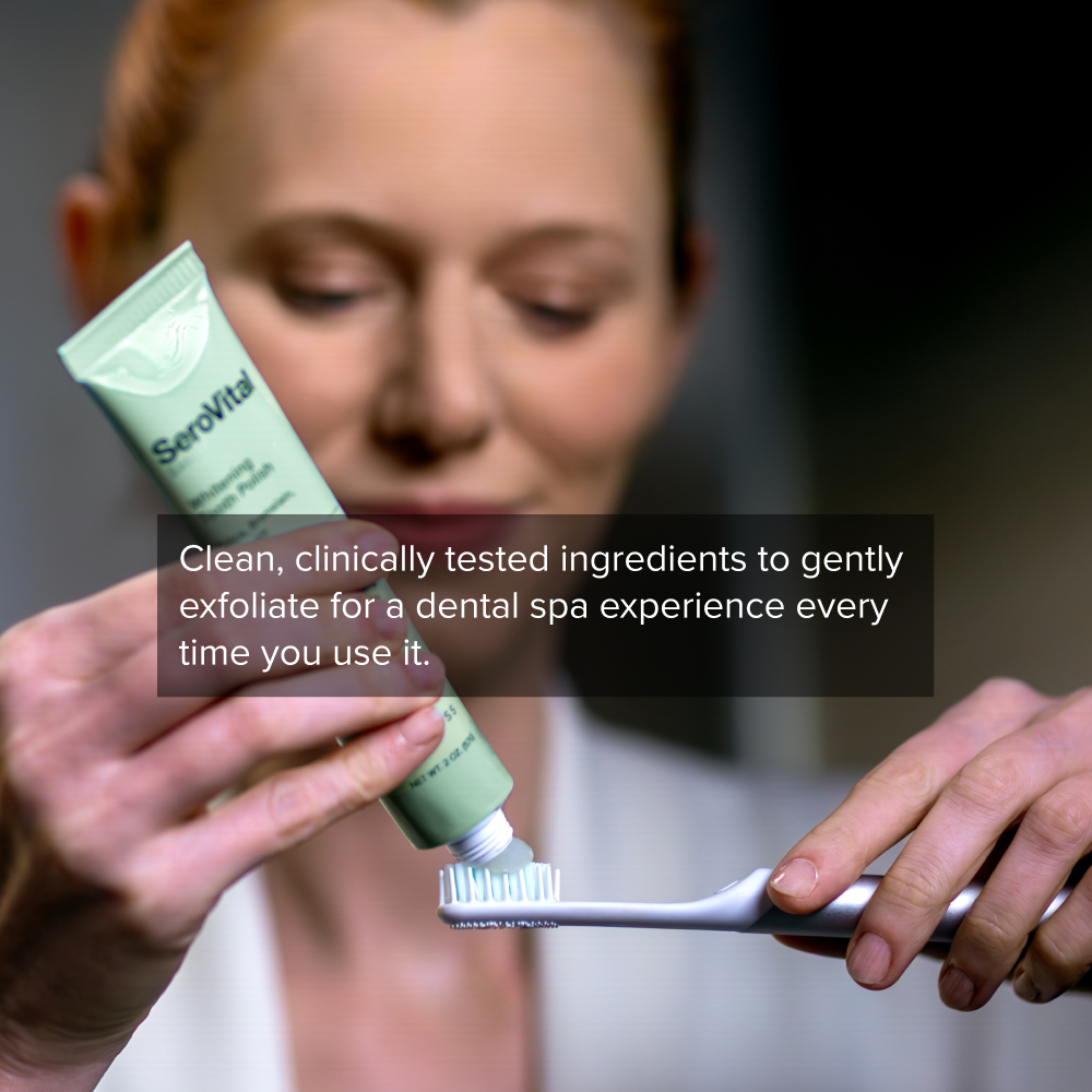 Person holding a tube of SeroVital toothpaste and a toothbrush with text about dental care.