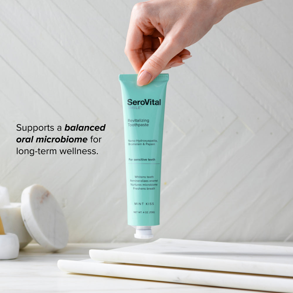 SeroVital toothpaste tube held by a hand with text about oral microbiome support.