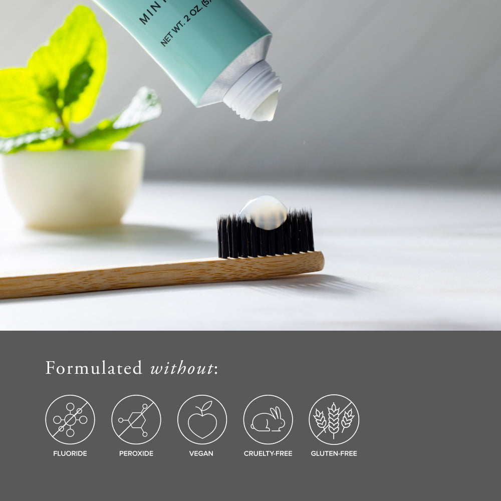 SeroVital Toothpaste being applied to a bamboo toothbrush with a plant in the background