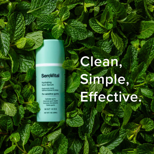 SeroVital Hydrating Gum Serum bottle resting on a bed of fresh mint leaves