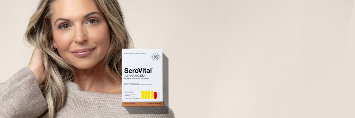 A woman with blonde hair wearing a beige sweater holds a box of SeroVital supplements against a warm beige background.