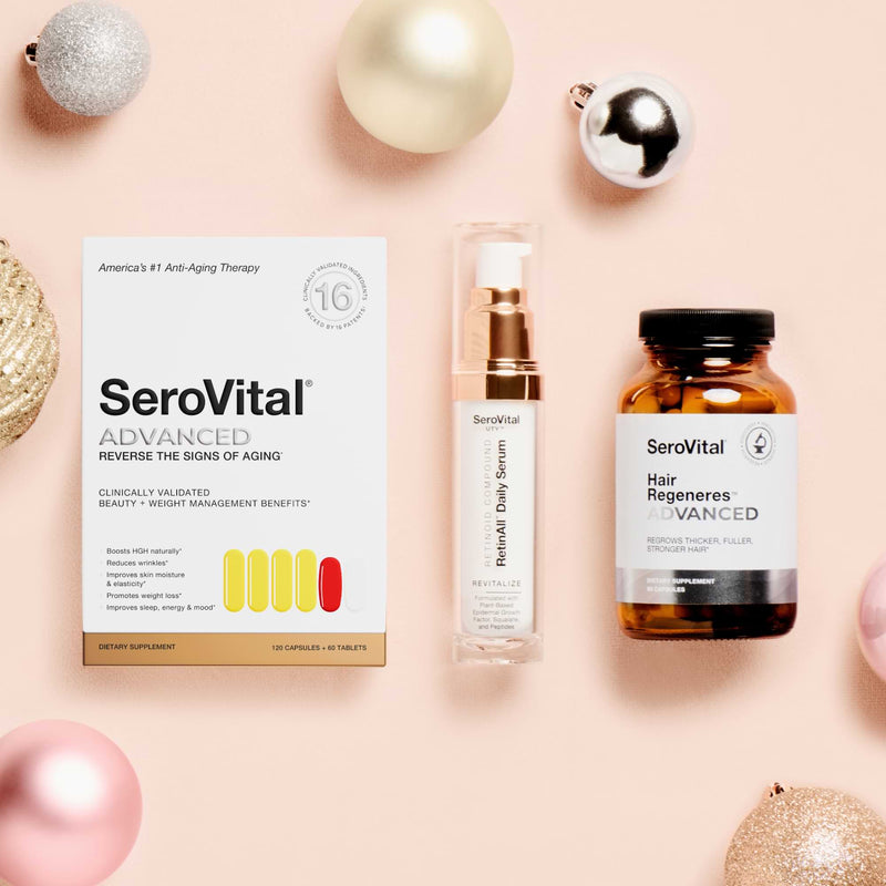 SeroVital skincare and hair care products on a pink background with Christmas ornaments.