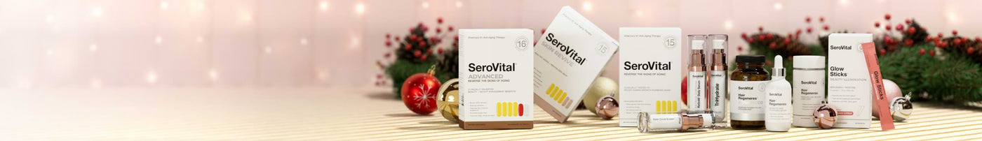 Serovital Advanced, Skin Revive, Hair Regeneres, and Glow Sticks products in a festive holiday display with pinecones and ornaments.