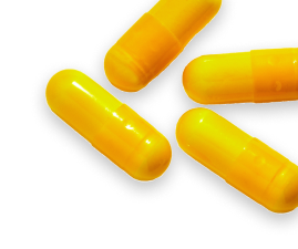 Four bright yellow capsules arranged on a light surface, casting soft shadows.