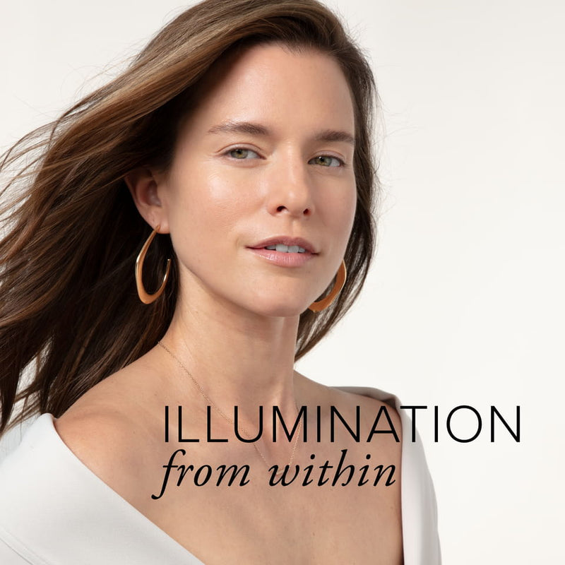 A white woman with brunette hair and glowing skin showing illumination from within.
