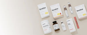 A flat lay of various SeroVital anti-aging and skin health products, including boxes, bottles, a tub, and individual packets, on a neutral background.