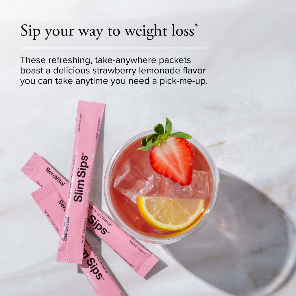 Strawberry lemonade drink with pink packets on a marble surface
