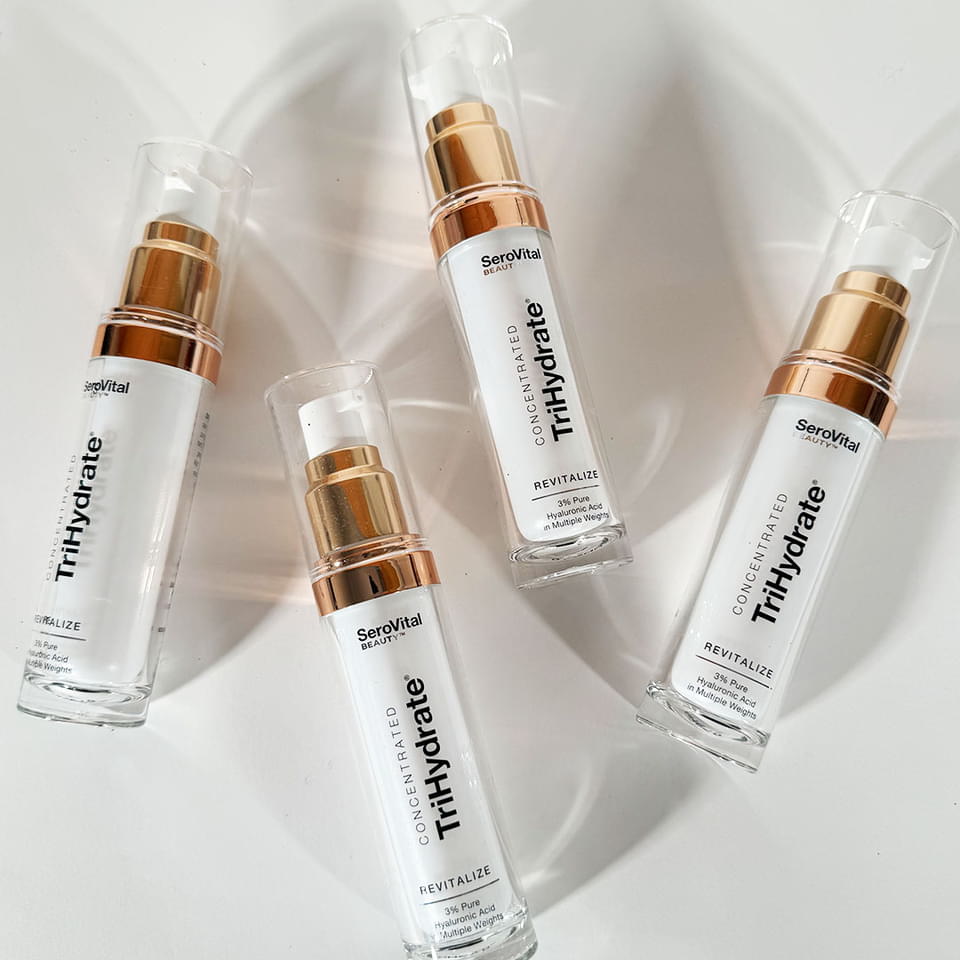 Multiple bottles of hydrating serum Trihydrate lying on a white background