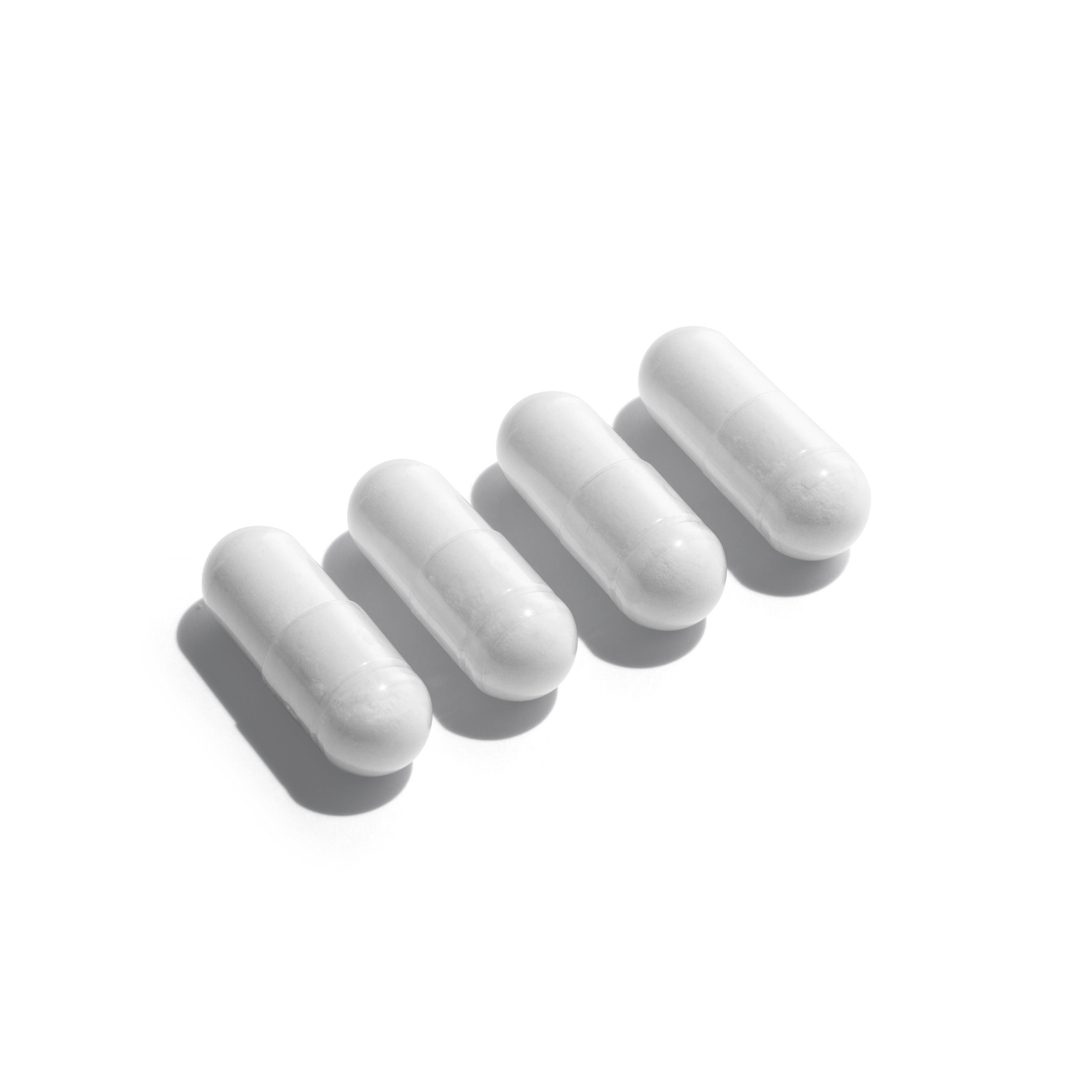 Four white ClearBalance capsules by SeroVital arranged in a diagonal row on a white background