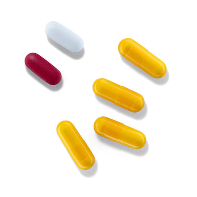  4 yellow HGH-boosting capsules next to a red and white tablet from the three-part anti-aging kit SeroVital ADVANCED